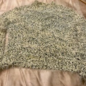 Loose stretchy silver threads through out. Soft and lightweight.